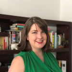 Professional headshot of Ali Mattson, wearing a green shirt in front of a bookcase.