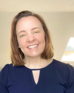 Headshot of Amy Getchell wearing a navy blue shirt in an indoor setting.