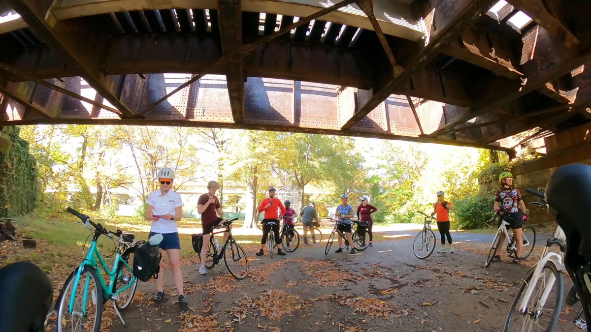 Bike event participants under a bridge