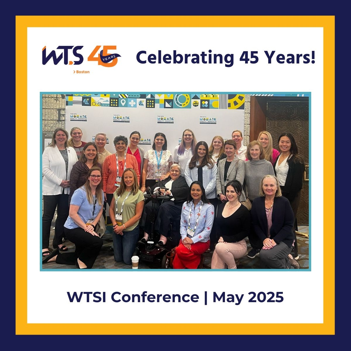 Group of around 20 women in business casual attire pose for the camera in front of a backdrop screen. A blue and yellow border surrounds the graphic, and the words Celebrating 45 Years appears in blue above the photo. Below the photo reads WTSI Conference May 2025 in blue.