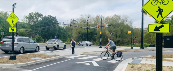 Bicyclist in crosswalk at intersection.