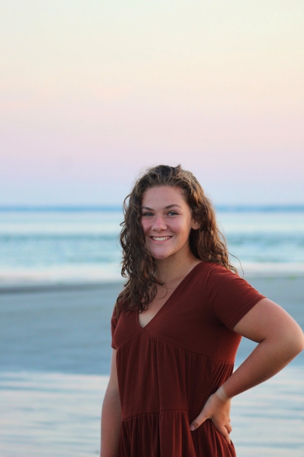 Girl wearing read with ocean in the background