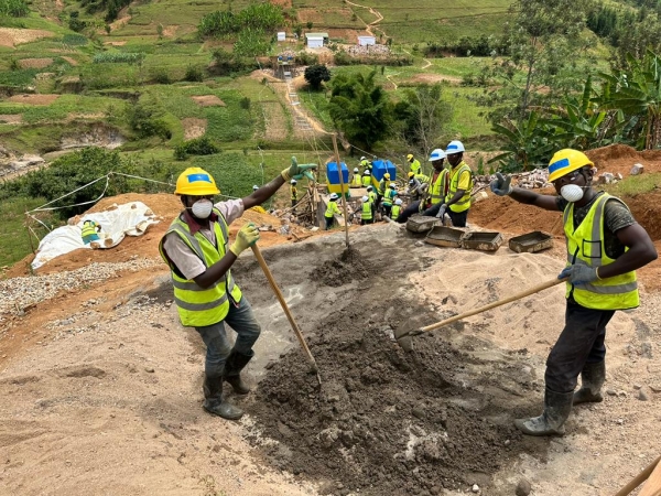 Community members mixing by hand for the surface of the abutments.