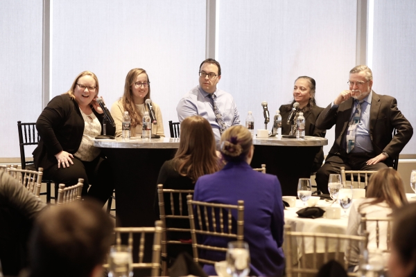 The MassDOT Bridge Group panel sitting at tables on stage at the February luncheon during their presentation.