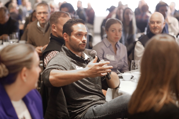 An audience member asking a question into a microphone at the February luncheon.