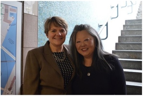 Photo of Lisa Brothers and Hyun-A Park, past Public Art Committee co-chairs, at the unveiling of the WTS-Boston Public Art Project titled "Network" at South Station in 2019.