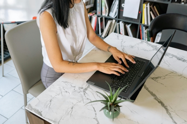 woman typing on laptop