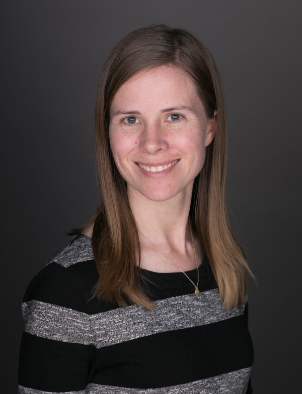 Woman with long brown hair smiling