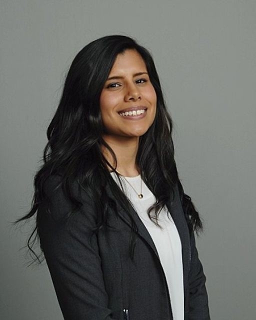 Woman with long brown hair smiling