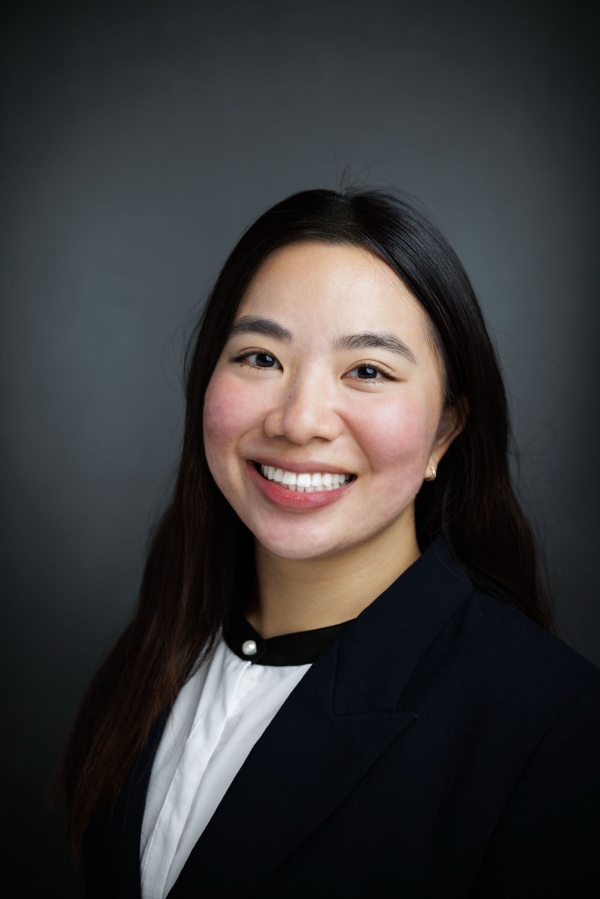 Woman with long brown hair smiling