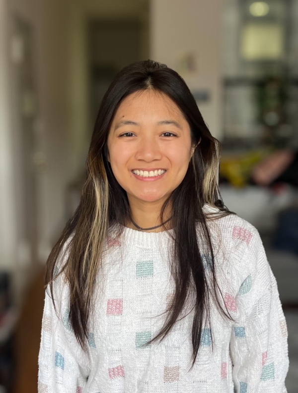 Woman with long brown hair smiling