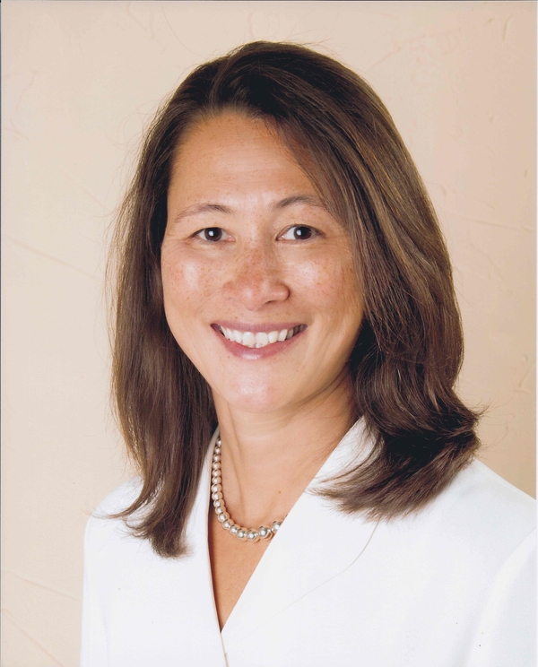 Headshot of Woman with brown hair and smiling. 