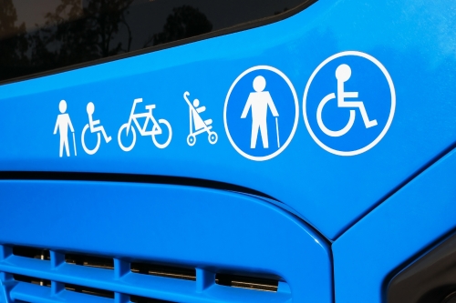 Blue bus with accessibility symbols