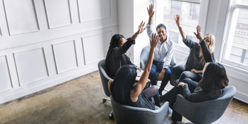 Group of women, hands raised