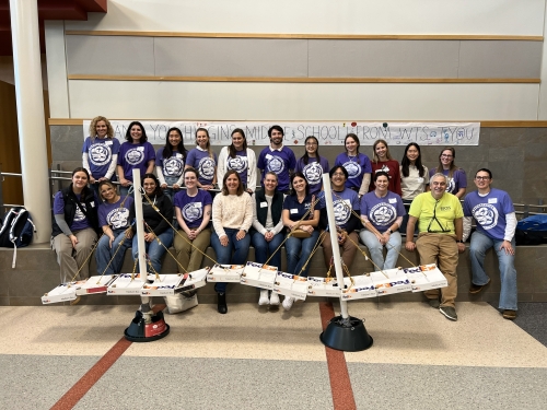 Group of volunteers in front of paper bridge