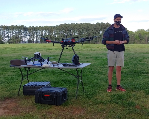 Professional describing drone in field