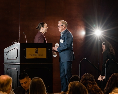 Woman presenting award to man