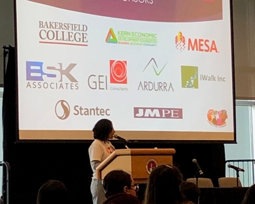 Speaker in front of large screen