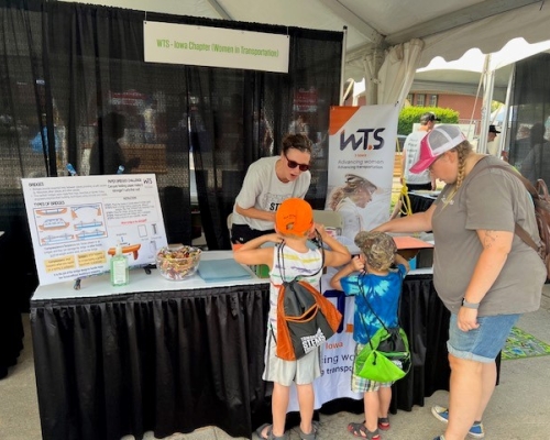 Photo of children visiting the WTS booth on STEM day at Iowa State Fair 2023