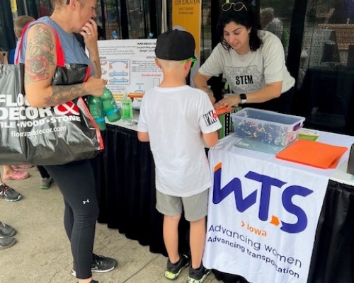 Photo of children visiting the WTS booth on STEM day at Iowa State Fair 2023