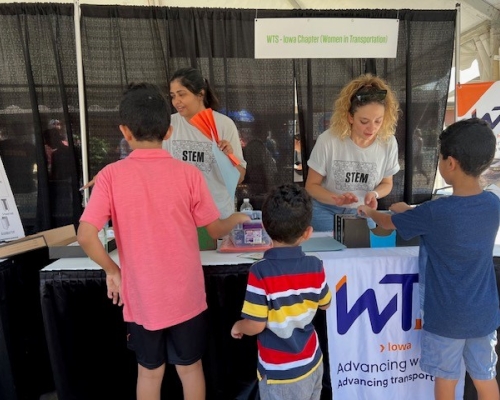 Photo of children visiting the WTS booth on STEM day at Iowa State Fair 2023