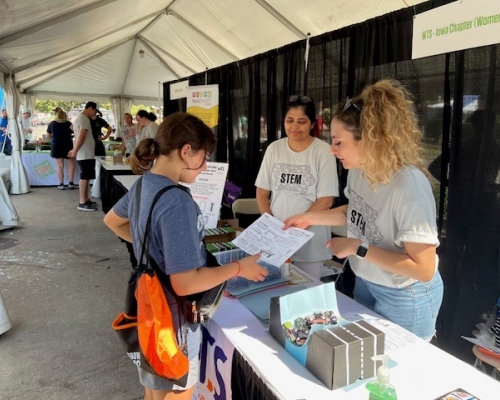 Photo of children visiting the WTS booth on STEM day at Iowa State Fair 2023