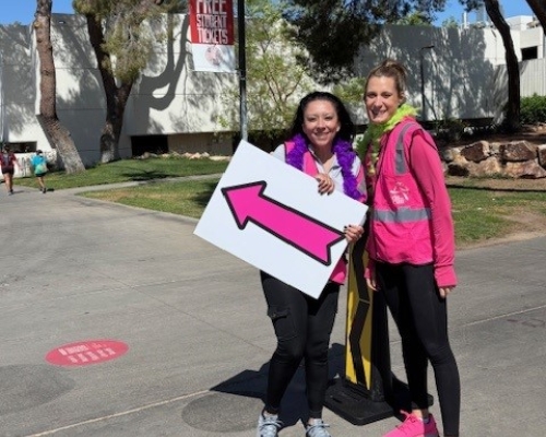 Volunteers with directional sign