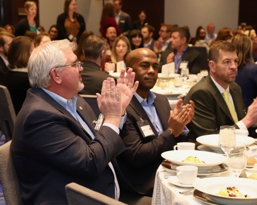 WTS luncheon attendees clapping 