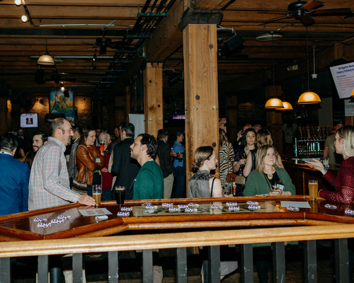 View of Wynkoop Brewery and people engaging in conversations at the annual awards gala.