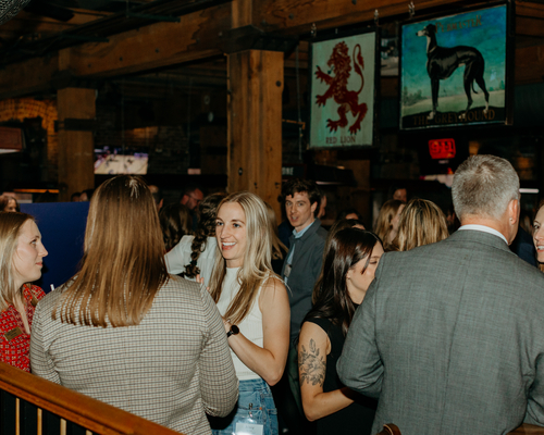 People conversing with each other at the annual awards gala. 