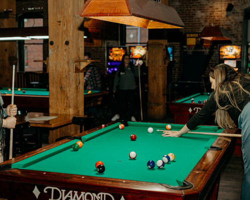 Two people playing pool. 