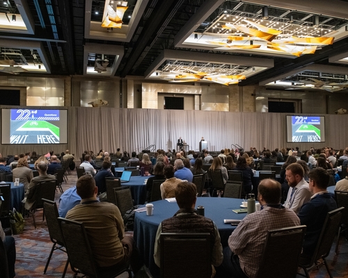 A large group of people gathered in a conference room. 