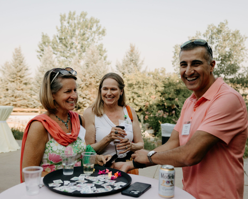 Three people smiling and chatting. Photos by Brooke Silverman