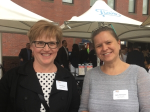 Two WTS members smiling at a previous membership mixer at Tia's Waterfront