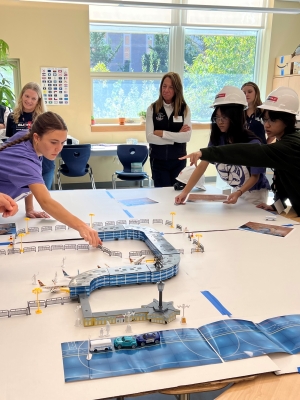 Students working together on building something on the table